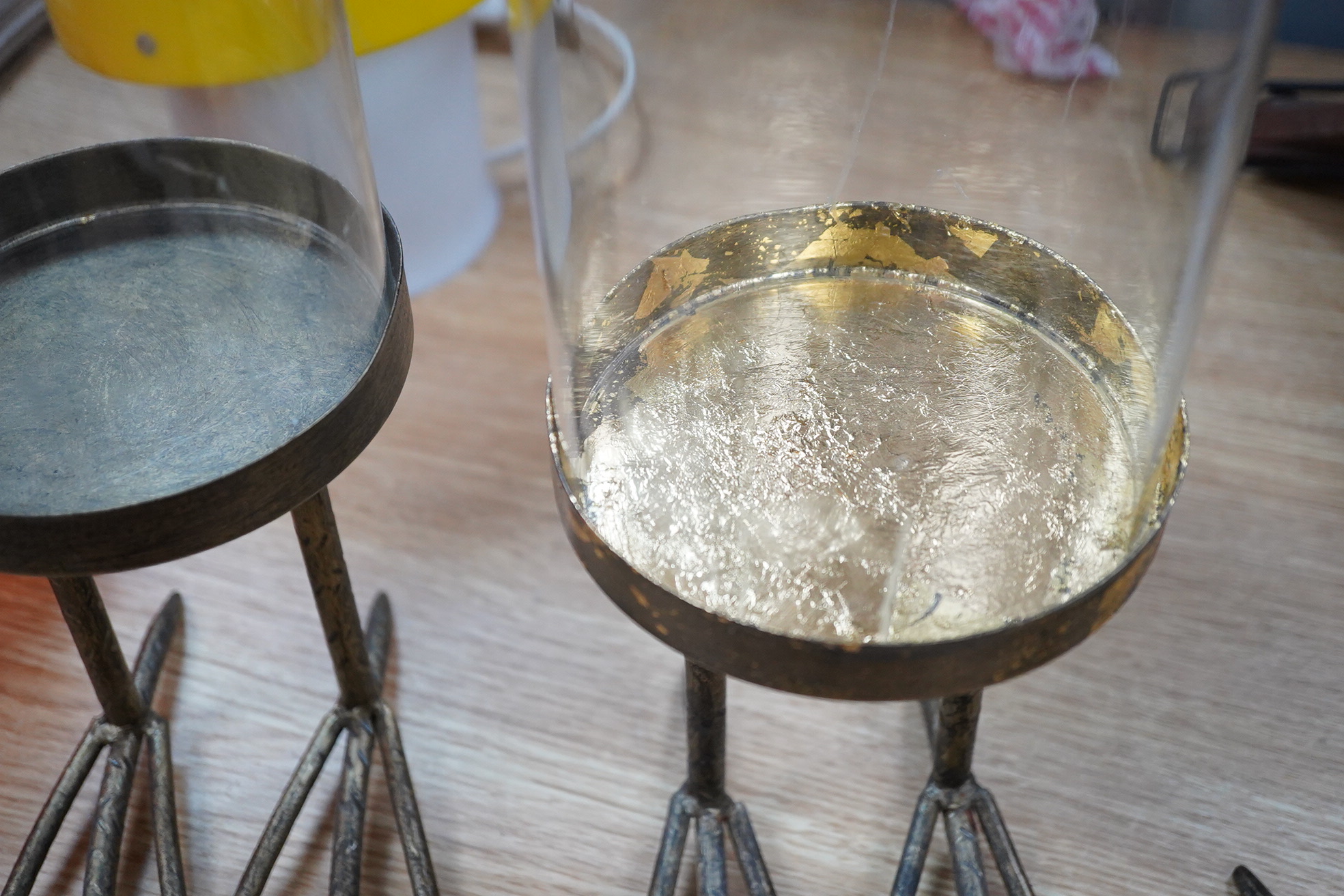 A trio of unusual glass domed display cases on ‘birds feet’ stands, 45cm